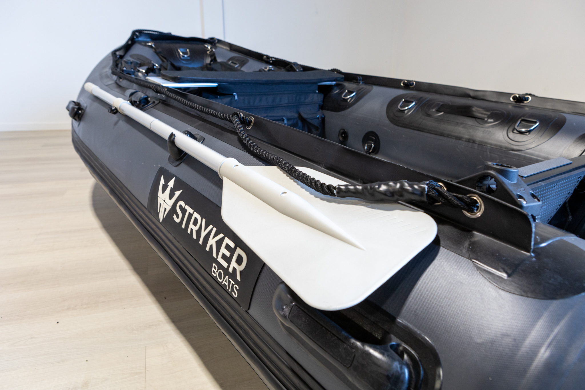 grey inflatable boat in showroom with new Stryker Logo 2024