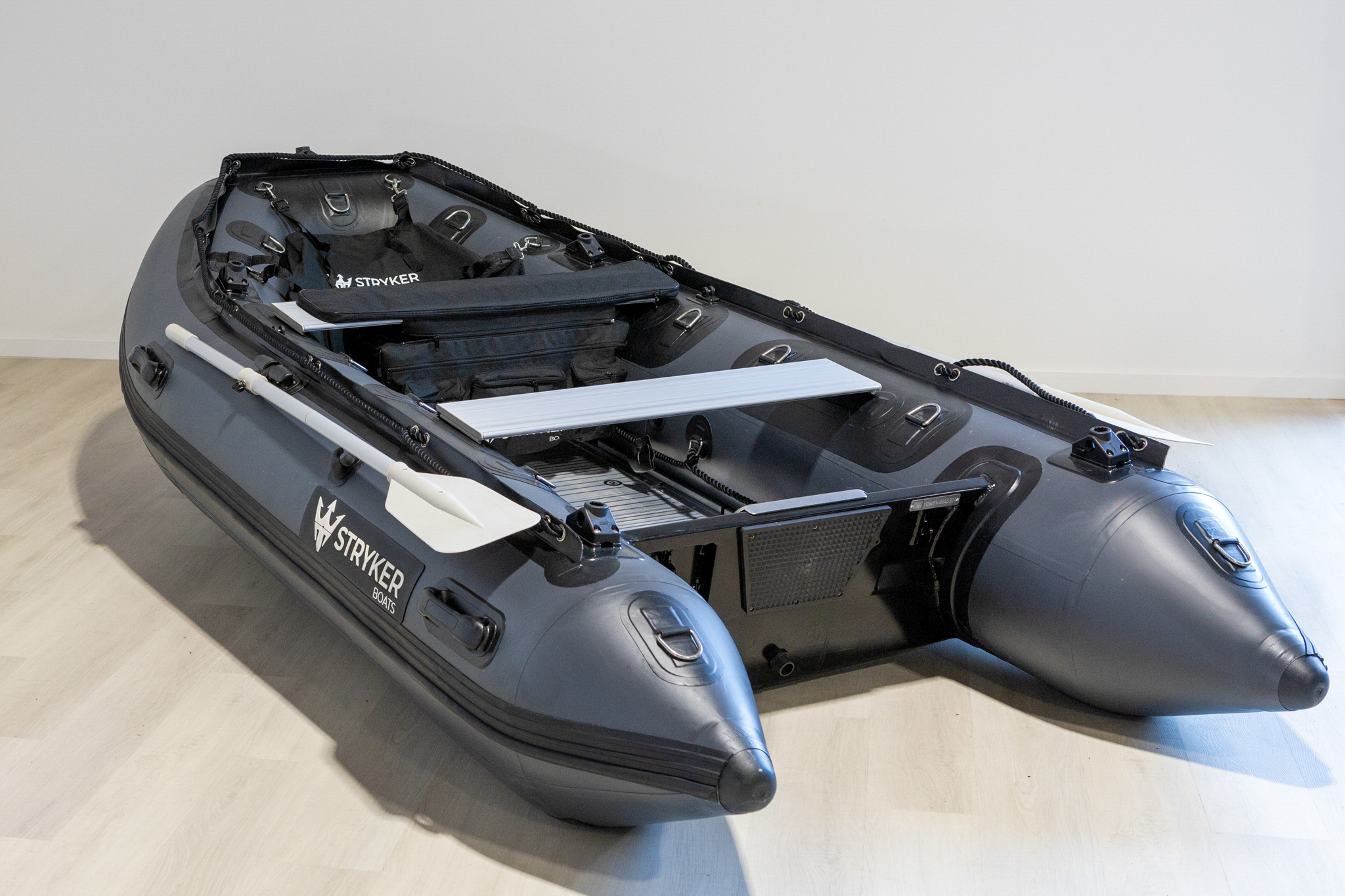grey inflatable boat in showroom with new Stryker Logo 2024