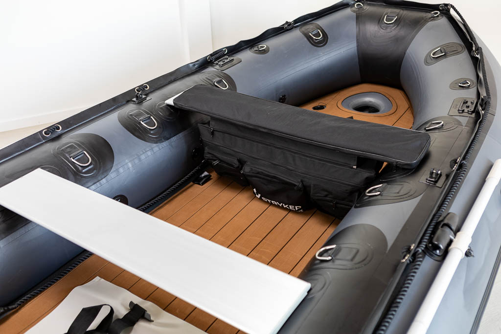 view inside of dark grey inflatable boat with high pressure airmat floor covered in Tan EVA foam.