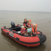 family on a red inflatable boat