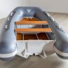 grey inflatable rigid hull inflatable boat with EVA foam on bench seats and floor. bow locker in front of boat also covered in Eva foam