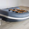 grey inflatable rigid hull inflatable boat with EVA foam on bench seats and floor. bow locker in front of boat also covered in Eva foam