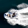 white tender yacht dinghy cruising on the water