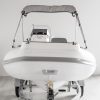 bow or front view of white rigid hull inflatable boat with bimini, integrated console and tohatsu outboard