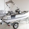 white rigid hull inflatable boat with bimini, integrated console and tohatsu outboard