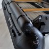 stealth black inflatable jet boat in showroom with a close up of top tubes
